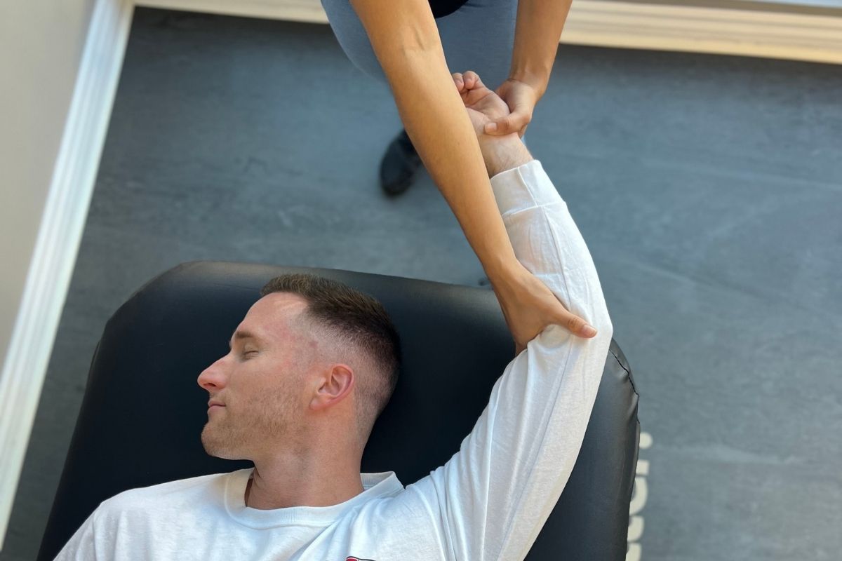 stretching a man's arm