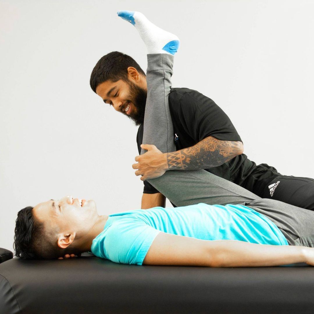 client having leg stretched, knee to chest