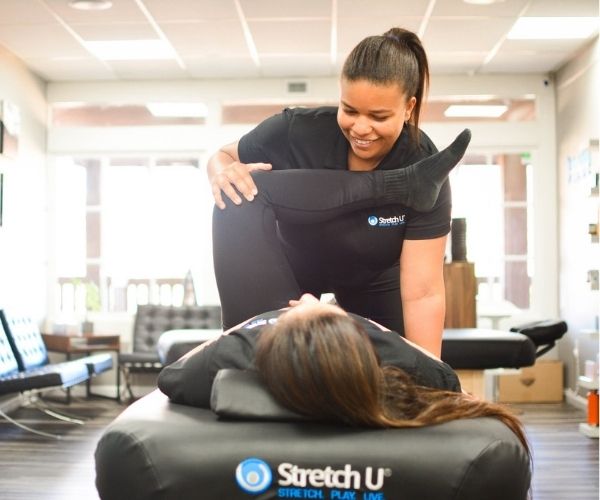 runner receiving stretch therapy