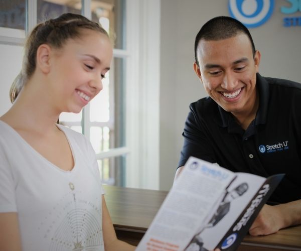 stretch tech and a customer in a stretch u studio