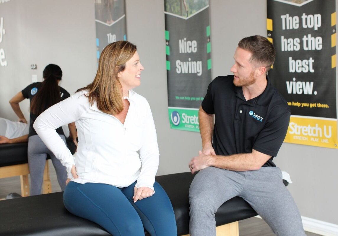 speaking to a patient about stretching